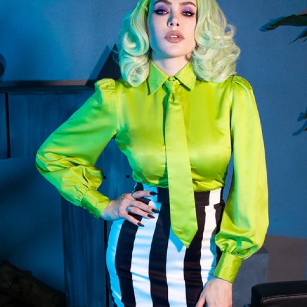 Vibrant Green Blouse with Black and White Striped Skirt